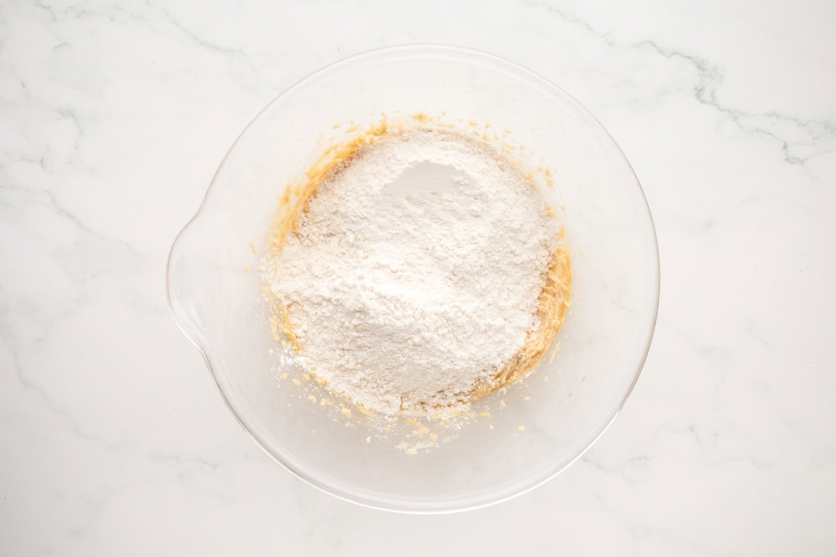 Dry ingredients added to the wet ingredients in a bowl.
