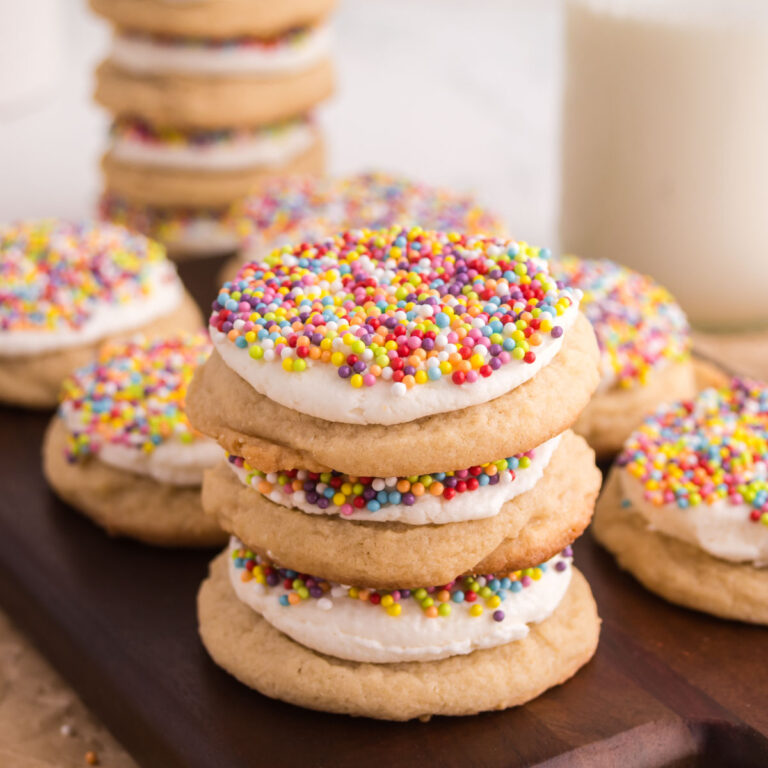 Dot cake cookies stacked on top of each other on a wooden board.