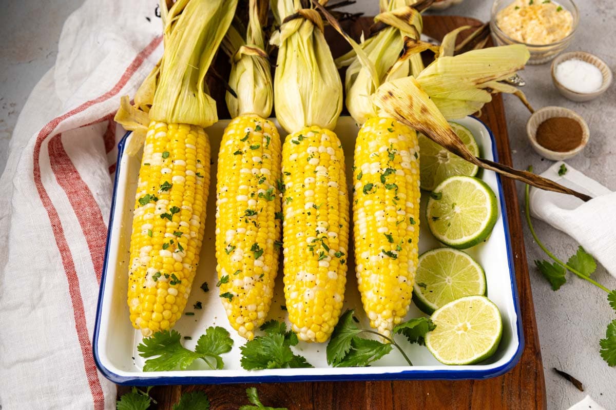 Grilled on the cob with shuck on after being buttered and topped with parsley.