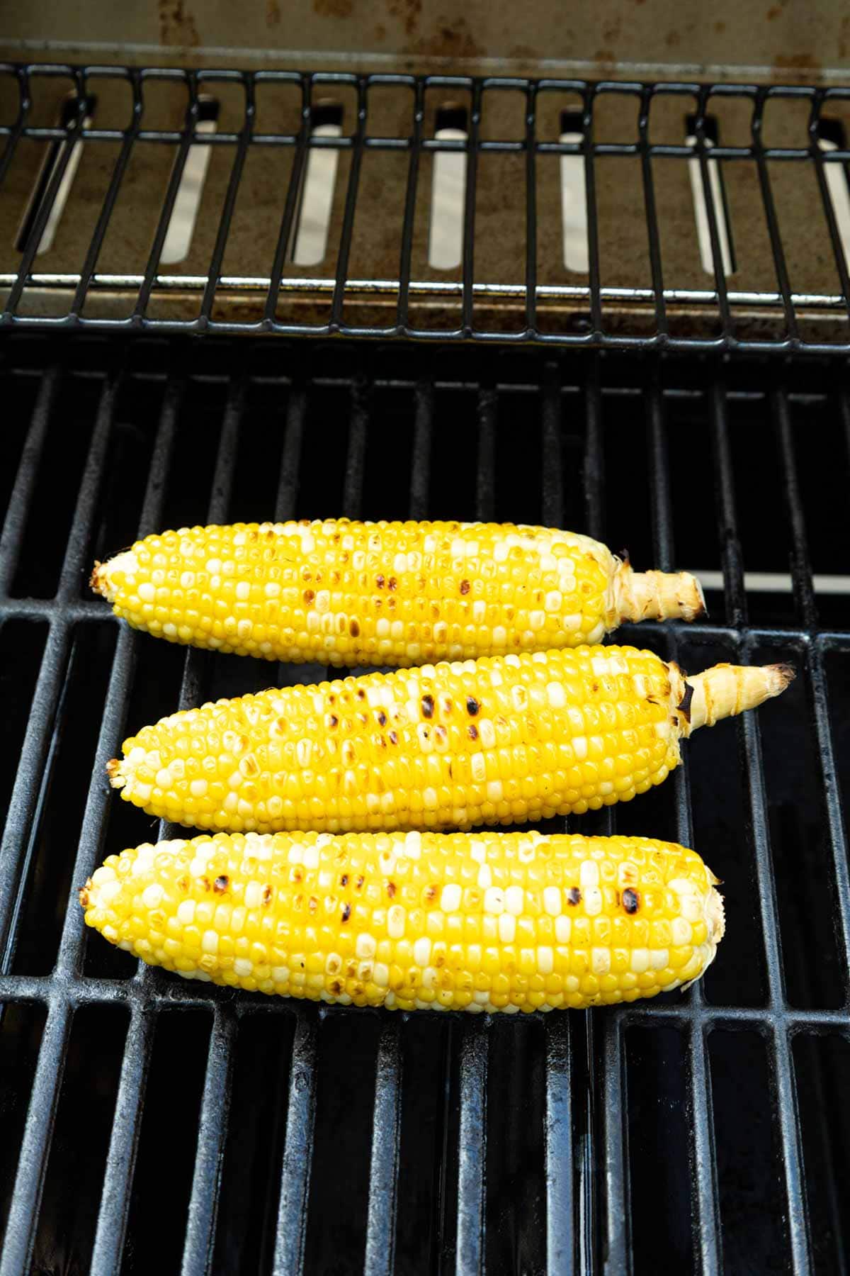 Corn without husk on directly on the grill with a very light char.