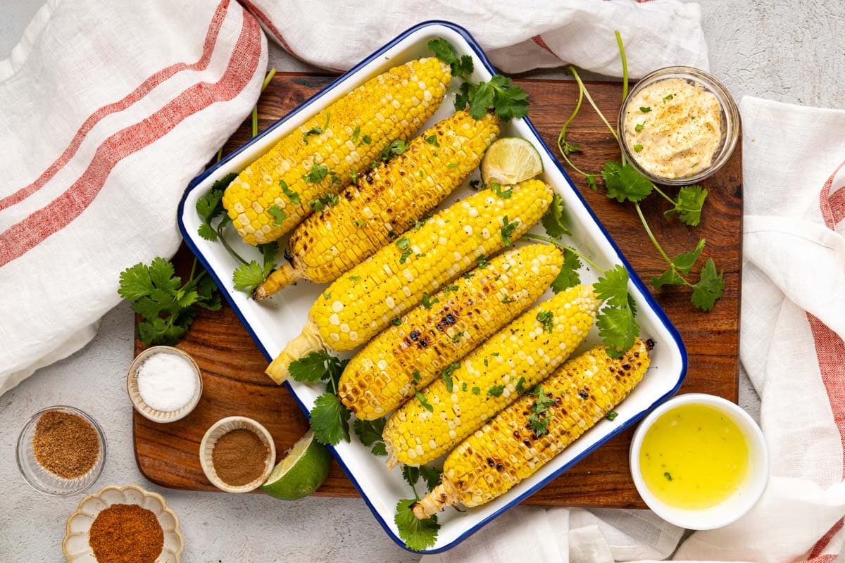 Grilled on the cob cooked directly on the grill on after being buttered and topped with parsley.