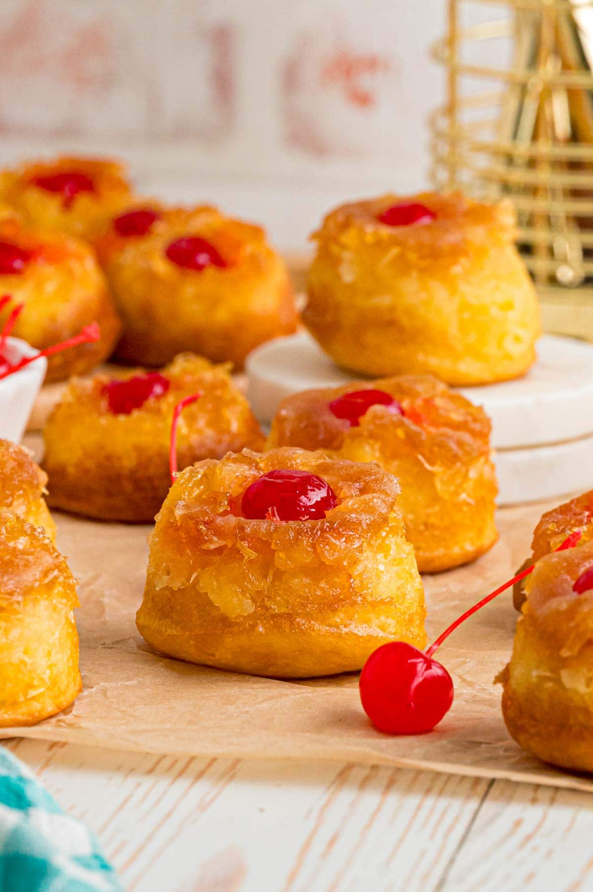 Pineapple upside down cupcakes on parchment paper.