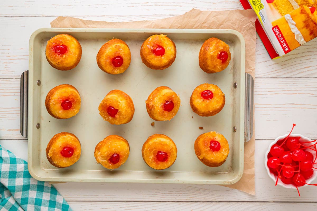 Pineapple Upside Down Cupcakes flipped over into a baking sheet.