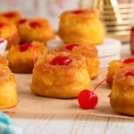 Pineapple upside down cupcakes on parchment paper.