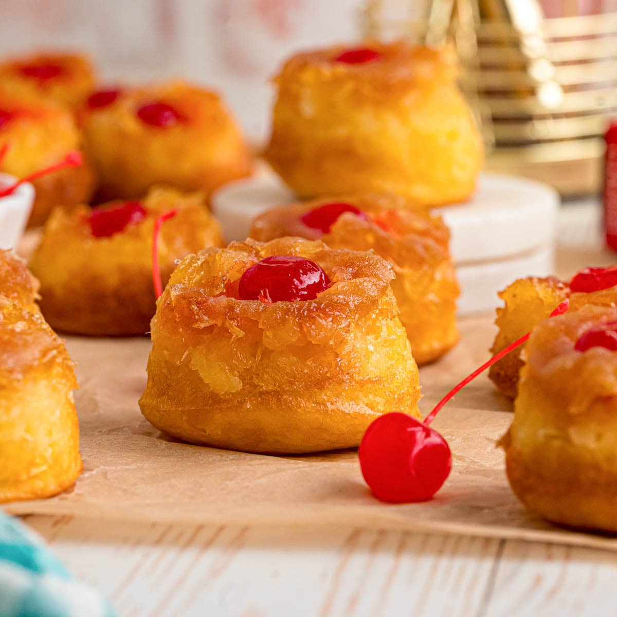 Pineapple upside down cupcakes on parchment paper.