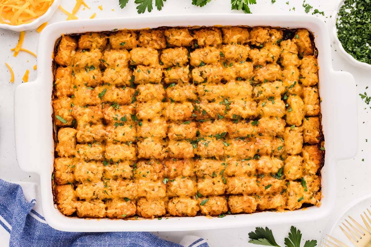 Overhead shot of baked sloppy joe tater tot casserole garnished with parsley.