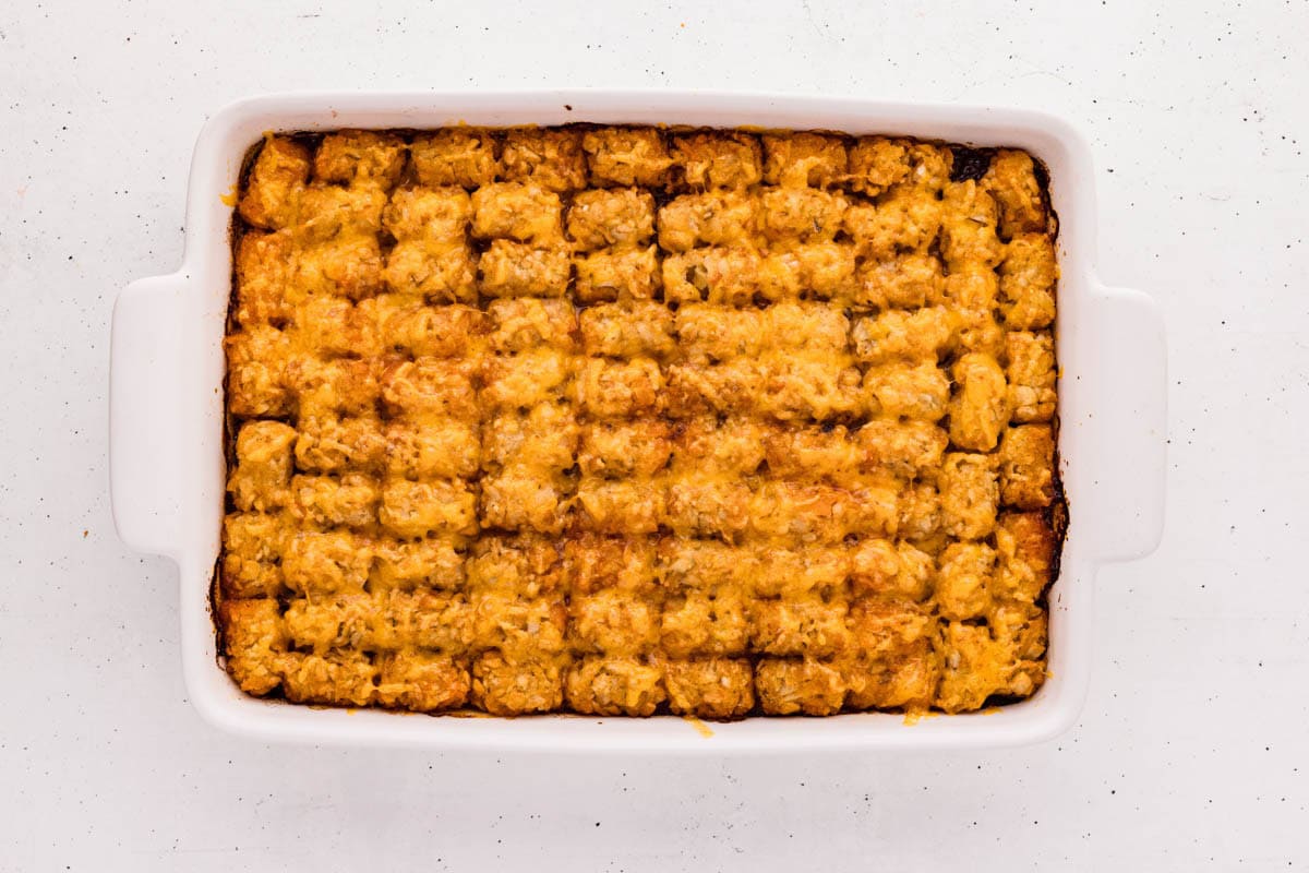 Finished baked sloppy joe tater tot casserole in a white baking dish.