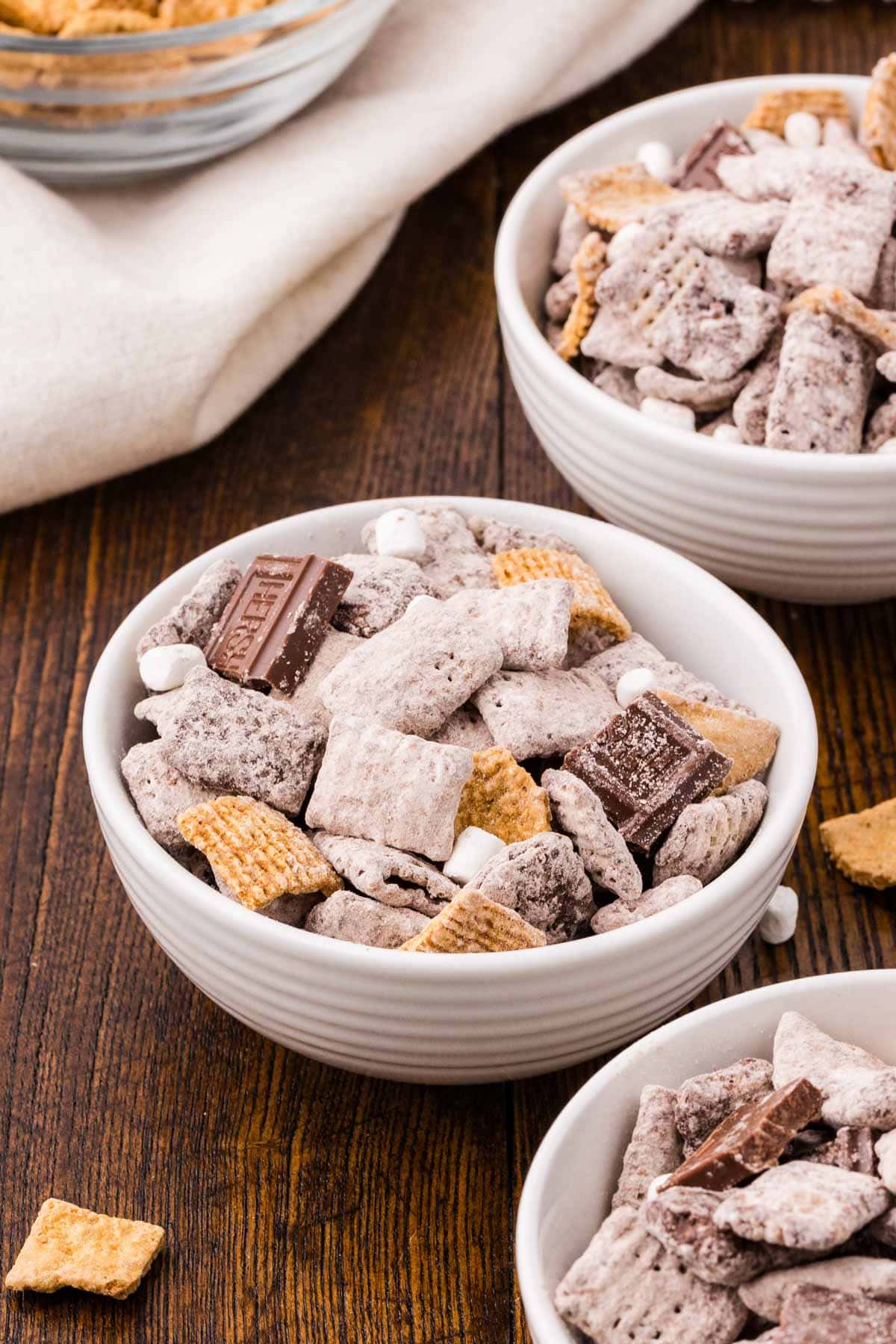 Bowl of s'mores muddy buddies with chocolate mixed in.
