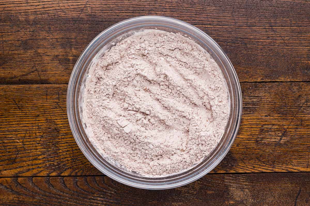 Powdered sugar and cocoa powder mixed together in a bowl.