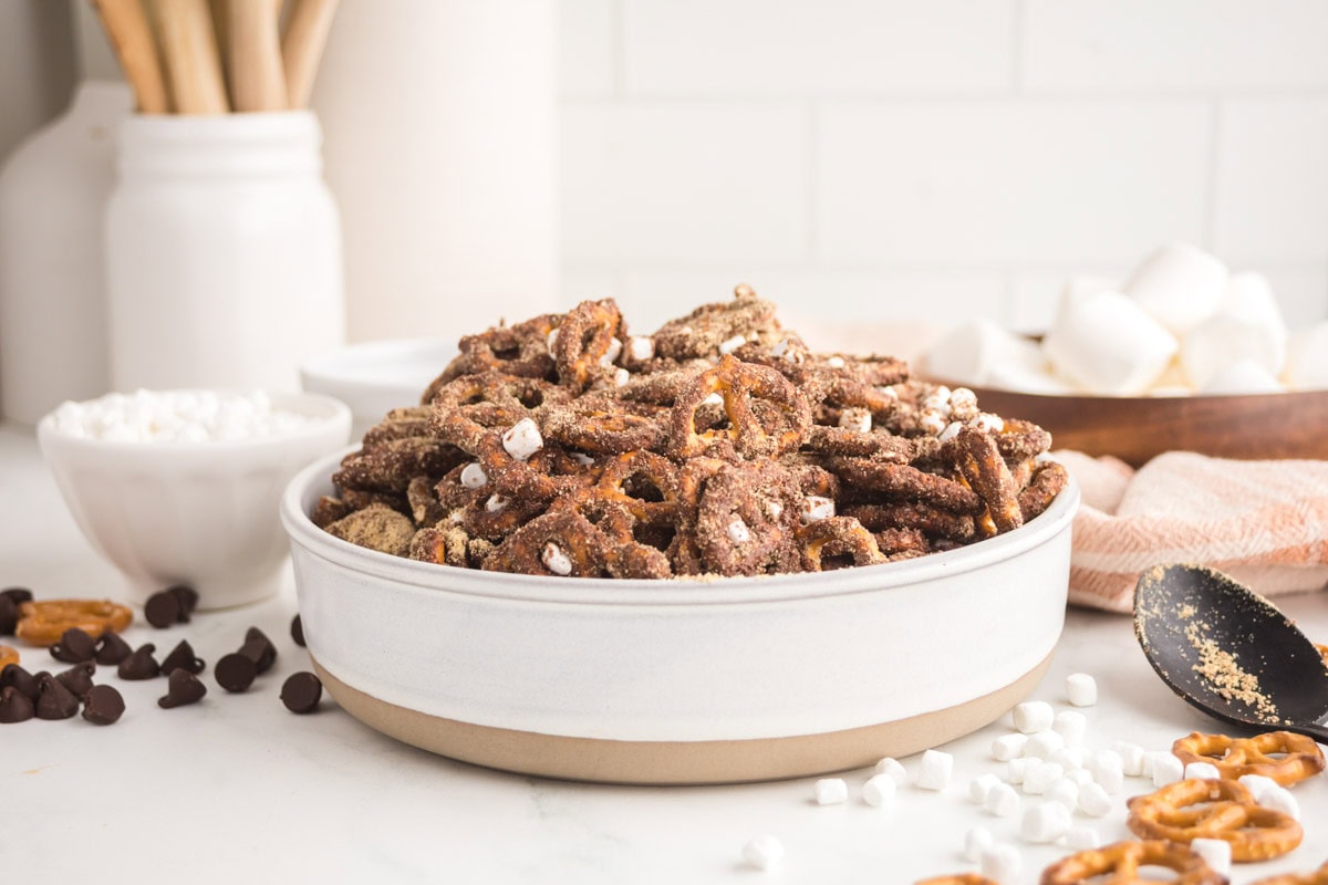 Side view of a bowl of s'mores pretzel mix.