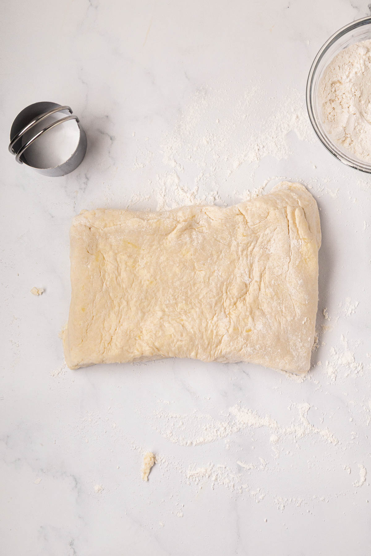 Dough pressed by hand into a rectangle.