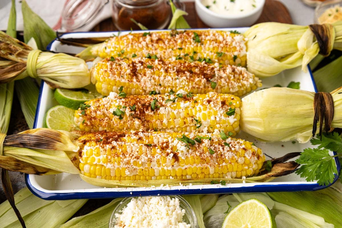 Elote on a decorative tray.