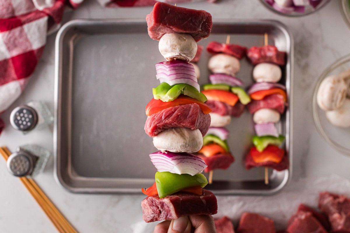 Skewers threaded with steak, bell peppers, onions and mushrooms.
