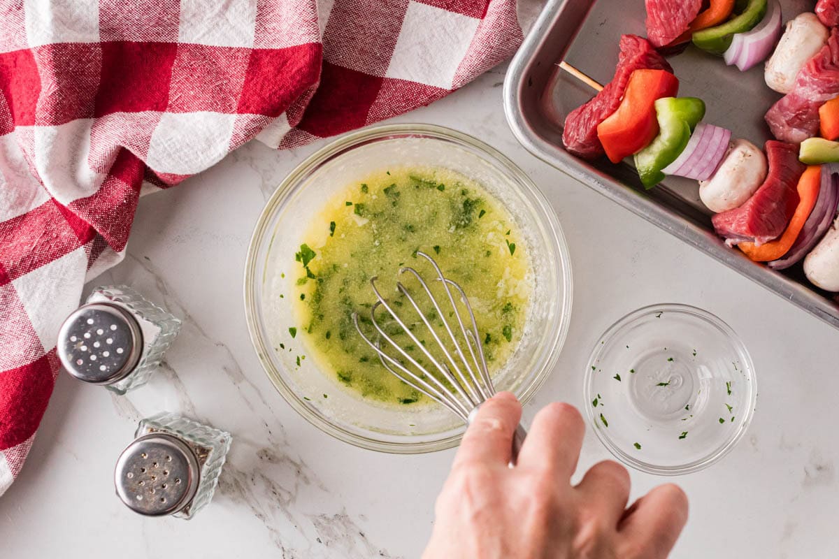 Melted butter, minced garlic and parsley whisked together in a bowl.