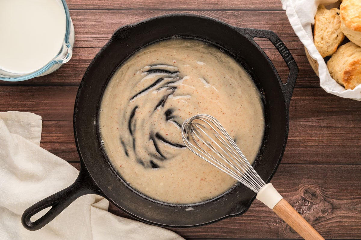 Whisking flour in the skillet to make the roux