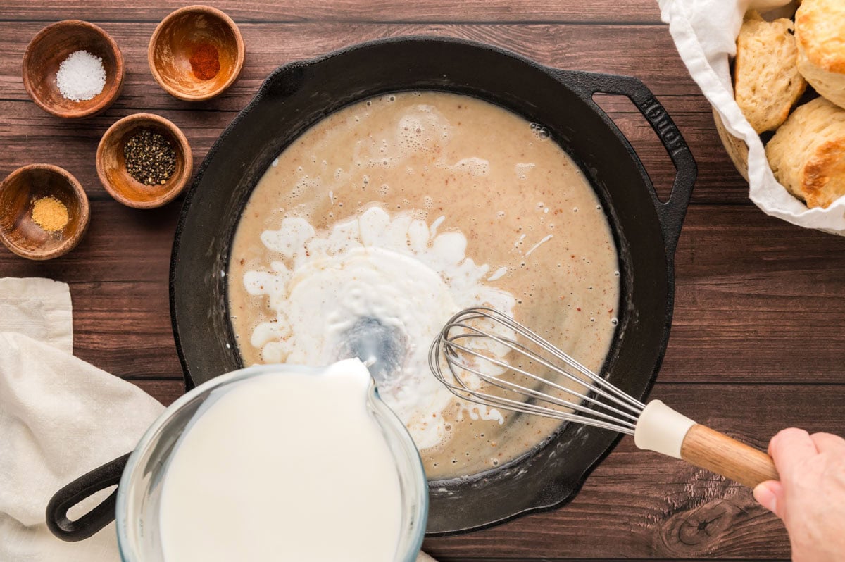 Adding milk to the roux.
