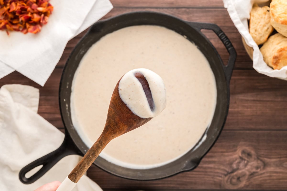 The back of a wooden spoon coated with bacon grease gravy.