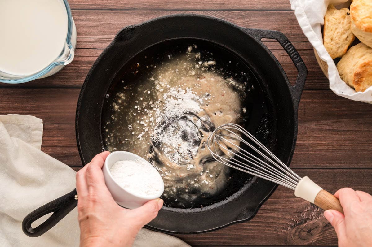 Adding flour to the skillet to make the roux