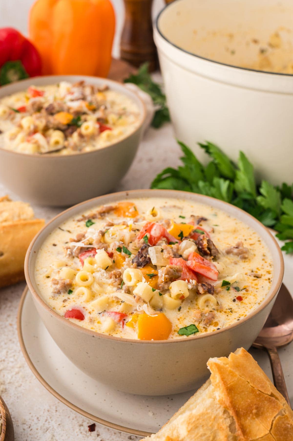 Side view of two bowls of creamy Italian sausage soup.