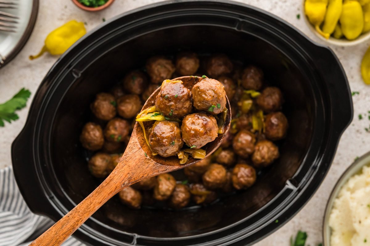Wooden spoon with a portion of Mississippi meatballs on it.