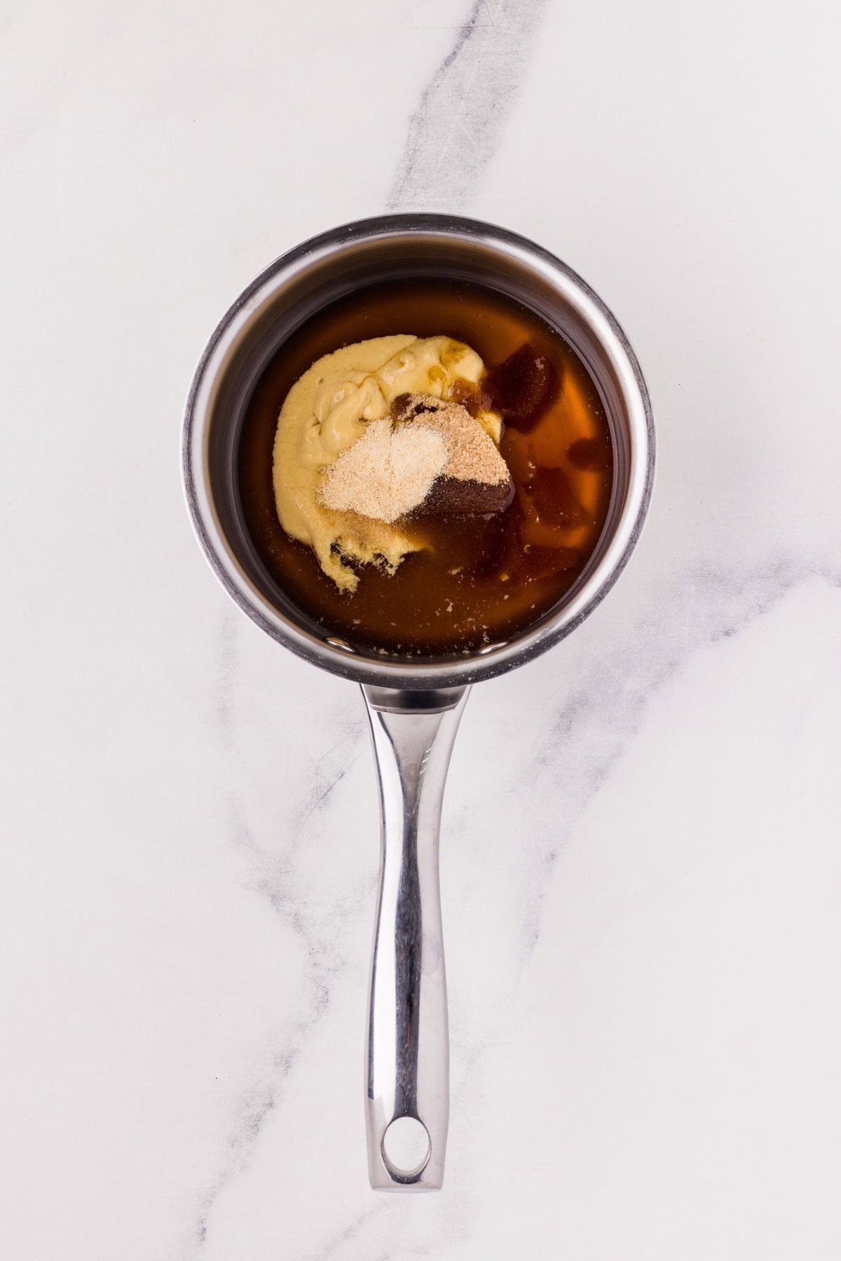Honey mustard sauce ingredients in a saucepan.