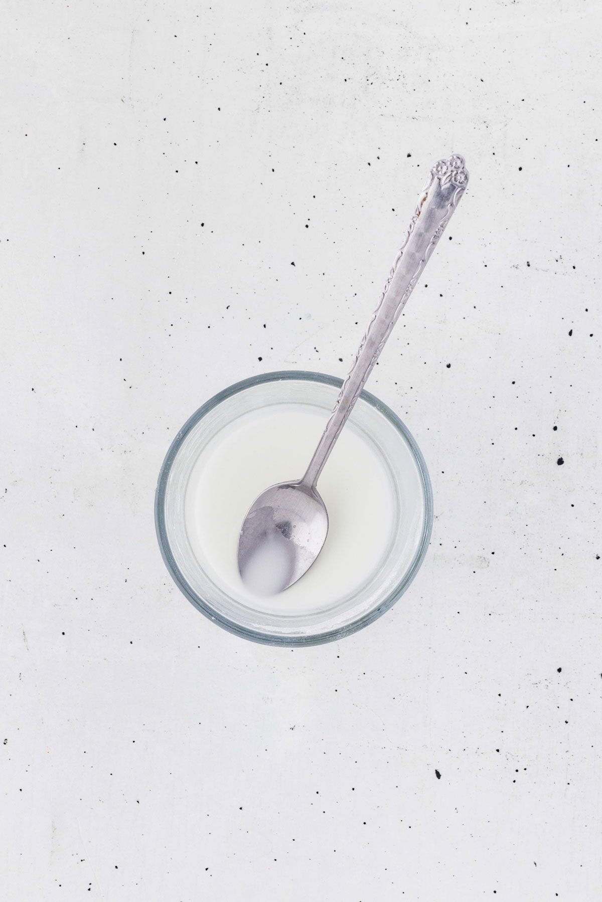 Mixing cornstarch and water in a small bowl with a spoon.