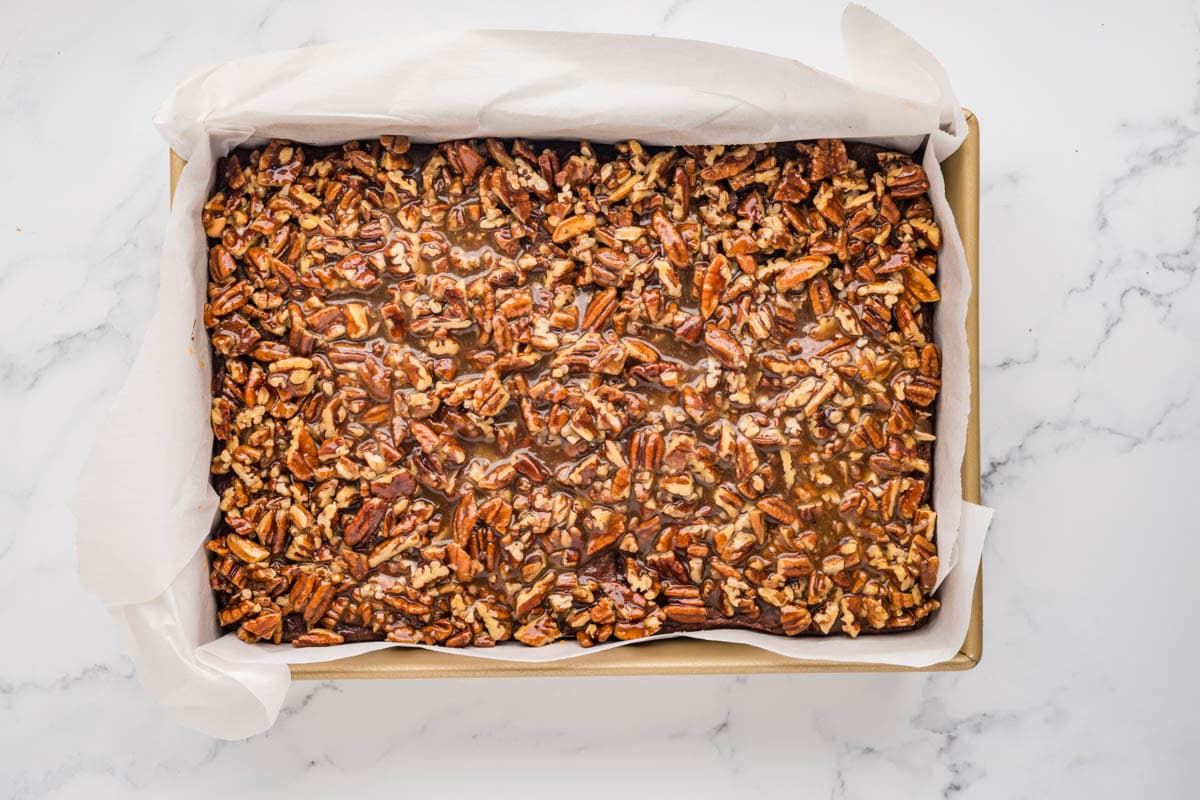 Pecan topping placed on top of the partially baked brownies.