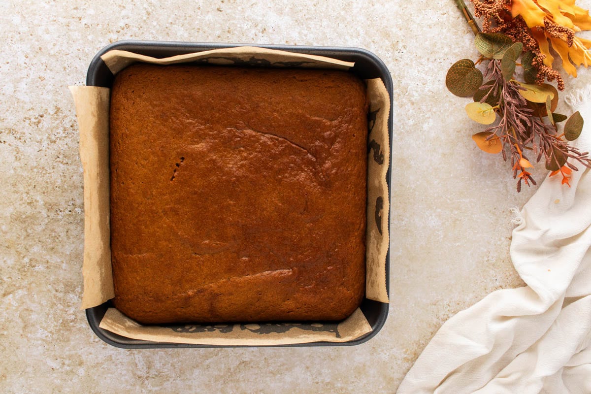 Baked pumpkin bars in a baking dish before frosting.