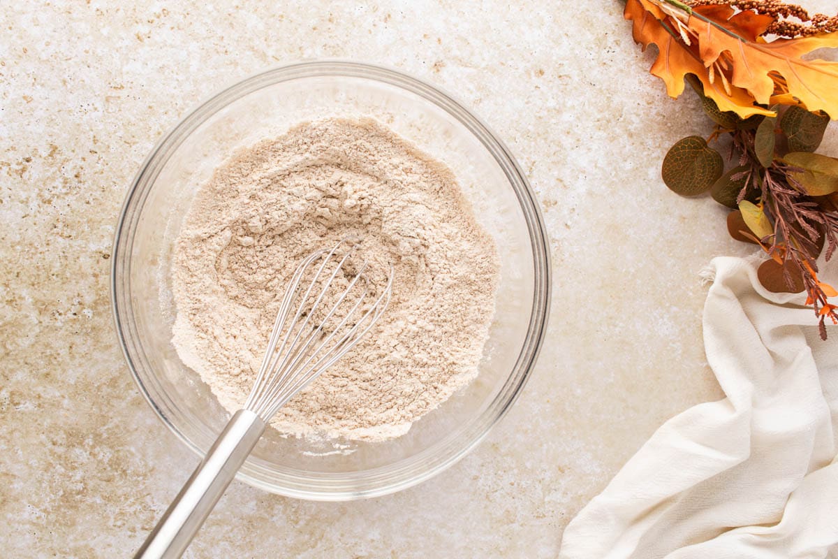 Dry ingredients for pumpkin bars whisked together in a bowl.