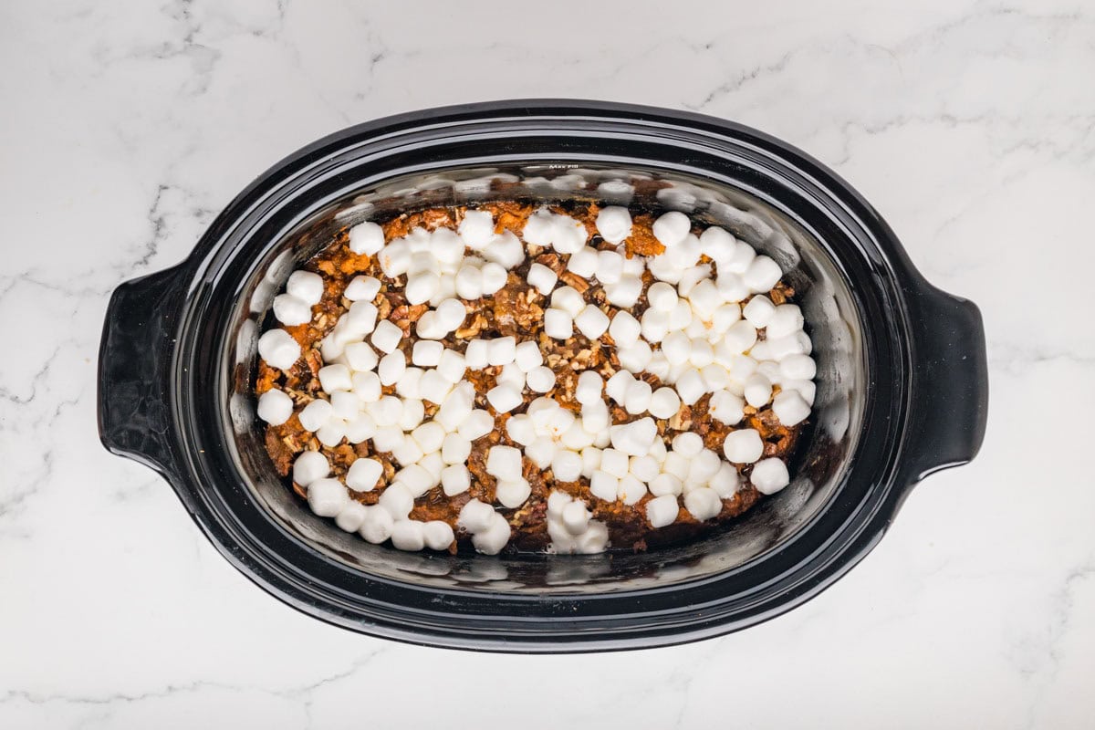 Melted marshmallows on top of the sweet potato casserole in a crockpot.