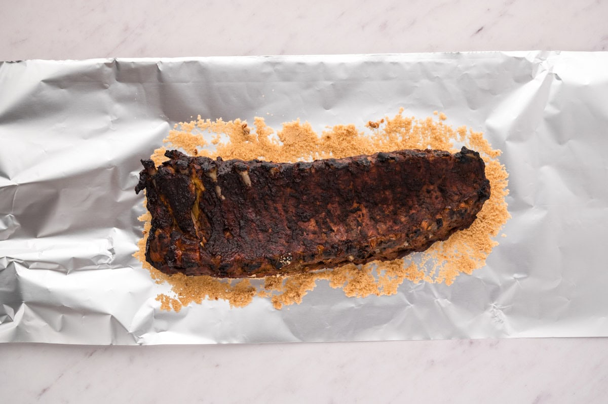 Brown sugar on a sheet of heavy-duty foil with the ribs placed meat side down on top of brown sugar.
