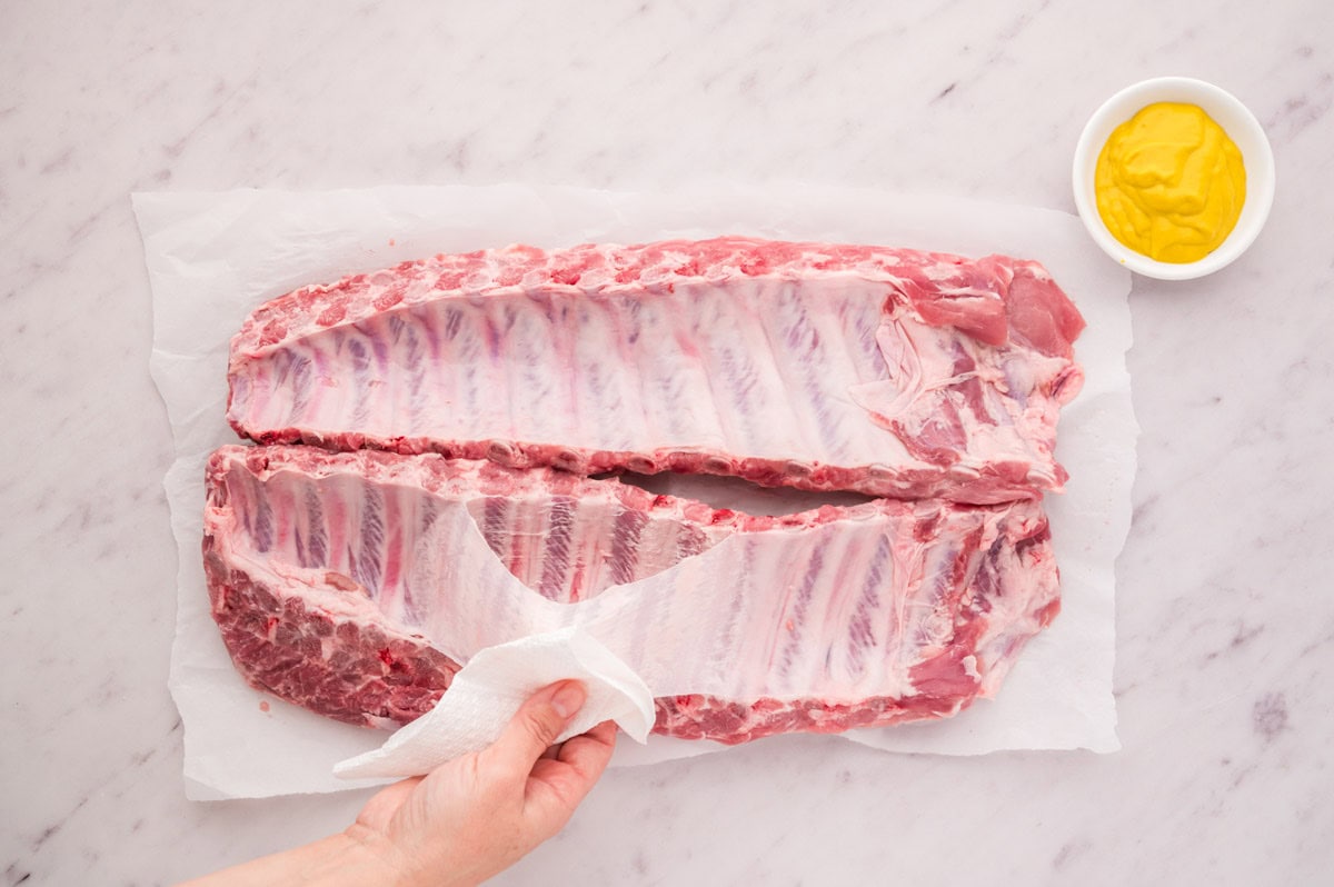 Lifting membrane from the pork ribs.