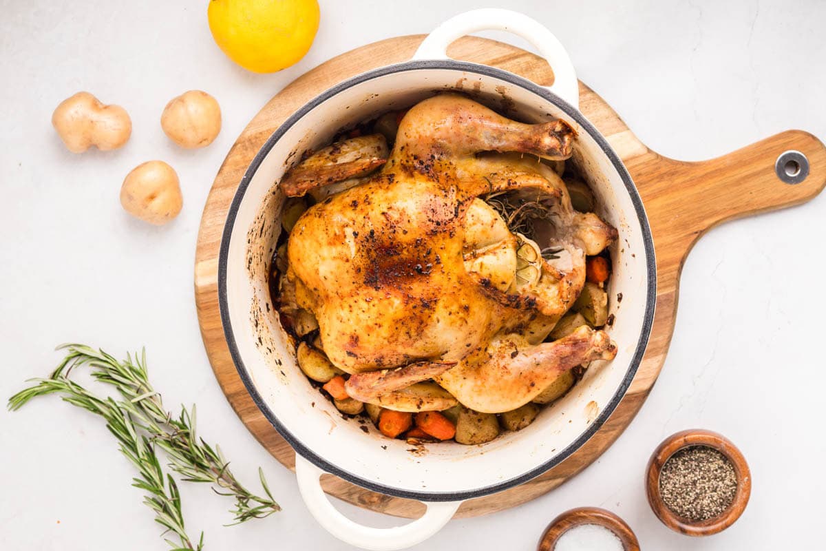 Roasted whole chicken in a Dutch oven.