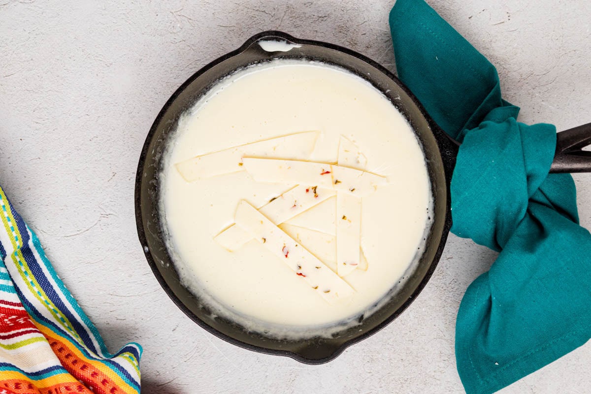 Pepper jack cheese slices added to the milk and cheese mixture.