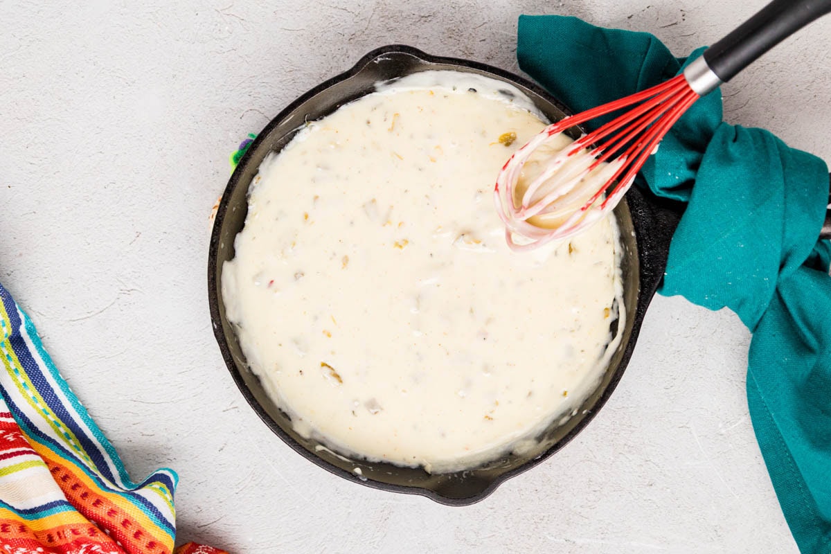 White queso dip all mixed together in a pan.